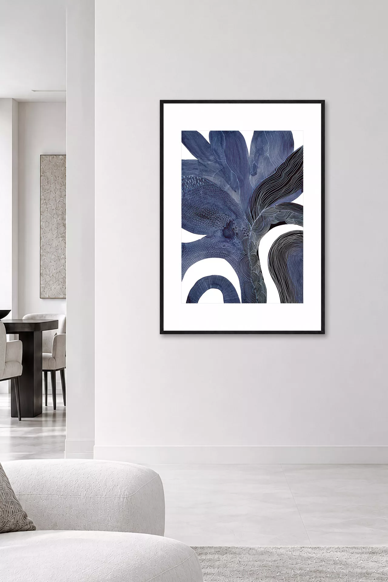 PETULA indigo abstract wall art with black frame in a bright contemporary living room